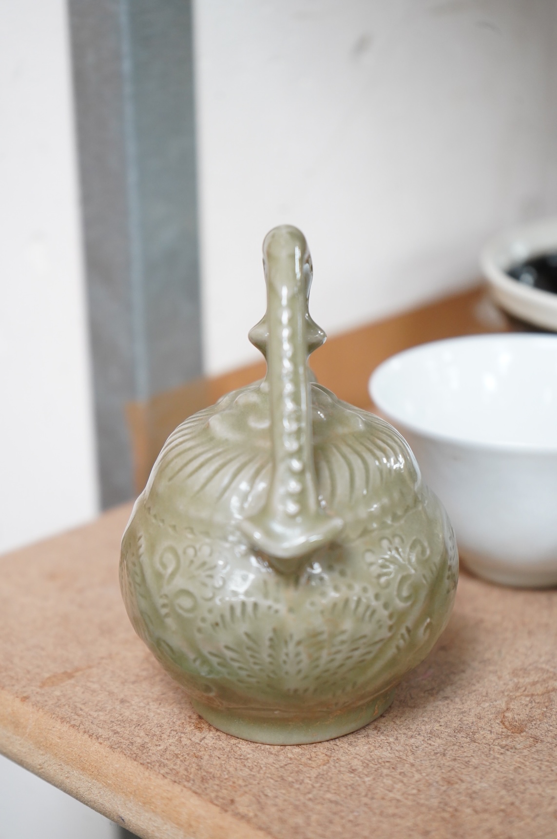 A collection of Chinese porcelain and pottery to include a naturalistic teapot, crackle glaze bowl and a ‘dragon’ bowl, largest 10cm in diameter
